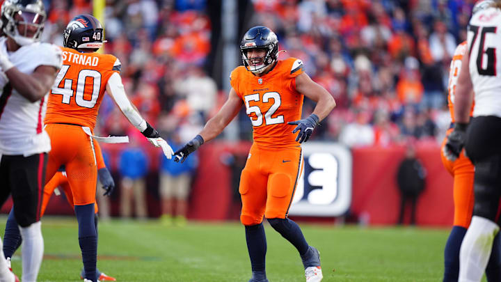 Nov 17, 2024; Denver, Colorado, USA; Denver Broncos linebacker Jonah Elliss (52) and linebacker Justin Strnad (40) celebrate a play in the second half against the Atlanta Falcons at Empower Field at Mile High. Mandatory Credit: Ron Chenoy-Imagn Images