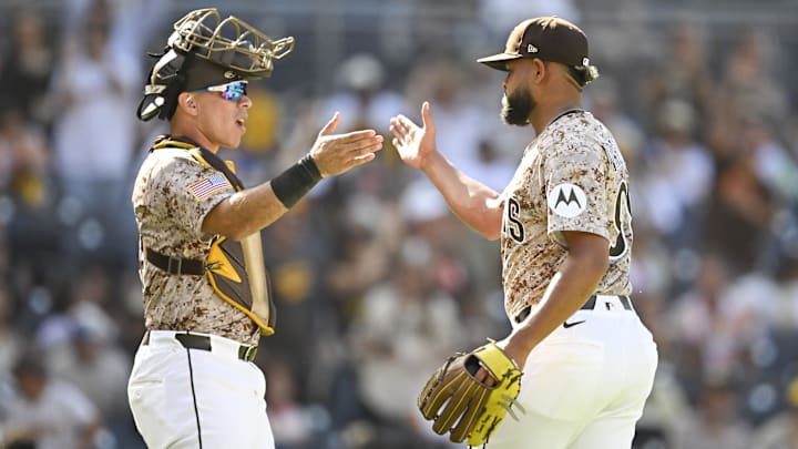 Randy Vasquez (98) and Freddy Fermin (54) celebrate after the Padres beat the Arizona Diamondbacks at Petco Park.