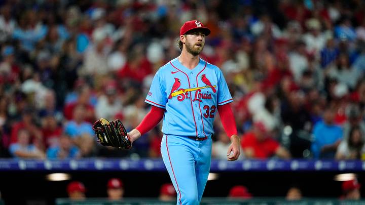 Sep 5, 2026; Denver, Colorado, USA;  St. Louis Cardinals pitcher Matthew Liberatore (32) reacts after a wild pitch scores a run for the Colorado Rockies during the fifth inning at Coors Field.  Mandatory Credit: Ron Chenoy-Imagn Images