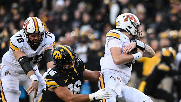 Oct 25, 2025; Iowa City, Iowa, USA; Minnesota Golden Gophers quarterback Drake Lindsey (5) alludes the sack of Iowa Hawkeyes defensive lineman Bryce Hawthorne (96) as offensive lineman Ashton Beers (78) attempts to block during the fourth quarter at Kinnick Stadium. Mandatory Credit: Jeffrey Becker-Imagn Images