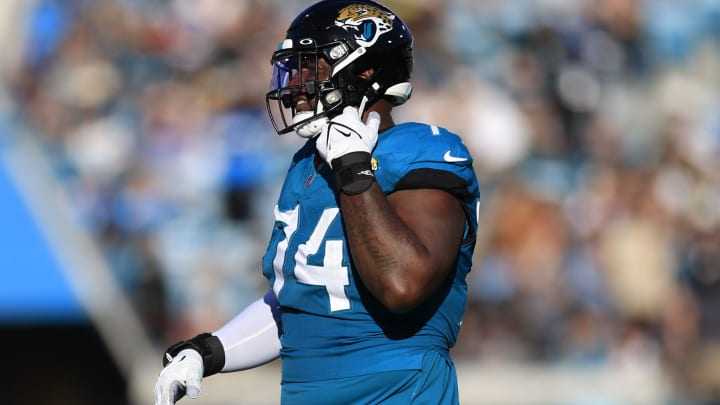 Jacksonville Jaguars offensive tackle Cam Robinson (74) walks off the field after being ejected for fighting with Carolina Panthers defensive tackle Derrick Brown (95), not shown, during the fourth quarter of a regular season NFL football matchup Sunday, Dec. 31, 2023 at EverBank Stadium in Jacksonville, Fla. The Jacksonville Jaguars blanked the Carolina Panthers 26-0. [Corey Perrine/Florida Times-Union]
