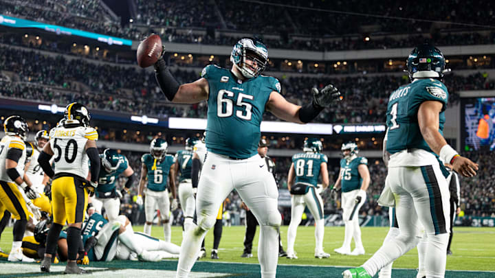 Dec 15, 2024; Philadelphia, Pennsylvania, USA; Philadelphia Eagles offensive tackle Lane Johnson (65) spikes the ball after quarterback Jalen Hurts (1) scores against the Pittsburgh Steelers during the fourth quarter at Lincoln Financial Field. Mandatory Credit: Bill Streicher-Imagn Images