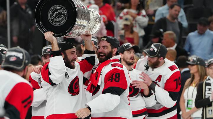 Jun 14, 2026; Las Vegas, Nevada, USA; Carolina Hurricanes left wing Jordan Martinook (48) hands the the Stanley Cup to defenseman Shayne Gostisbehere (4) after defeating the Vegas Golden Knights in game six of the 2026 Stanley Cup Final at T-Mobile Arena. Mandatory Credit: Stephen R. Sylvanie-Imagn Images Jun 14, 2026; Las Vegas, Nevada, USA; Carolina Hurricanes left wing Jordan Martinook (48) hands the the Stanley Cup to defenseman Shayne Gostisbehere (4) after defeating the Vegas Golden Knights in game six of the 2026 Stanley Cup Final at T-Mobile Arena. Mandatory Credit: Stephen R. Sylvanie-Imagn Images