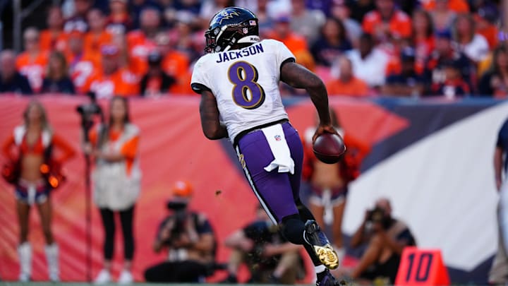 Oct 3, 2021; Denver, Colorado, USA; Baltimore Ravens quarterback Lamar Jackson (8) scrambles with the ball in the fourth quarter against the Denver Broncos at Empower Field at Mile High. 