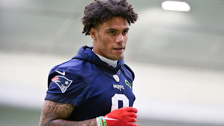 New England Patriots cornerback Christian Gonzalez (0) jogs to the sideline during minicamp held in the WIN Field House at Gillette Stadium.