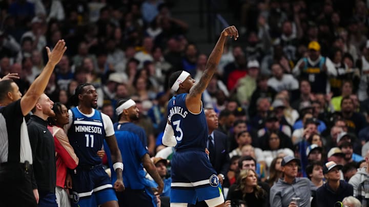 Mar 12, 2025; Denver, Colorado, USA; Minnesota Timberwolves forward Jaden McDaniels (3) reacts after a three point basket in the second half against the Denver Nuggets at Ball Arena. Mandatory Credit: Ron Chenoy-Imagn Images