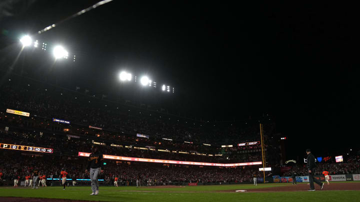 Apr 26, 2024; San Francisco, California, USA; Stadium LED lights flash as San Francisco Giants catcher Patrick Bailey (far right in orange) rounds the bases after hitting a walk-off home run against the Pittsburgh Pirates during the ninth inning at Oracle Park. Mandatory Credit: