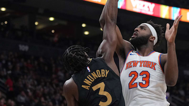 Jan 6, 2023; Toronto, Ontario, CAN; New York Knicks center Mitchell Robinson (23) drives to the basket  as Toronto Raptors forward O.G. Anunoby (3) tries to defend during the second quarter at Scotiabank Arena. Mandatory Credit: Nick Turchiaro-Imagn Images