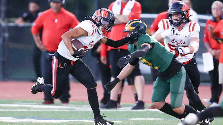 Clayton Valley WR Isaac Valdivia (18) fends off a San Ramon Valley defender in a 9-14-2024 game. 