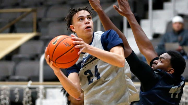 La Lumiere junior Darius Adams looks to put up a shot around teammate Jonas Muya during an open practice Thursday, Nov. 9, 2023, at the La Porte Civic Auditorium.
