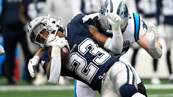 Dec 15, 2024; Charlotte, North Carolina, USA; Dallas Cowboys running back Rico Dowdle (23) is tackled by Carolina Panthers linebacker Josey Jewell (47) in the first quarter at Bank of America Stadium. 