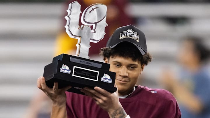 Dec 26, 2025; Phoenix, AZ, USA; Minnesota Golden Gophers wide receiver Jalen Smith (8) celebrates with the offensive MVP trophy after defeating the New Mexico Lobos during the Rate Bowl at Chase Field. Mandatory Credit: Mark J. Rebilas-Imagn Images