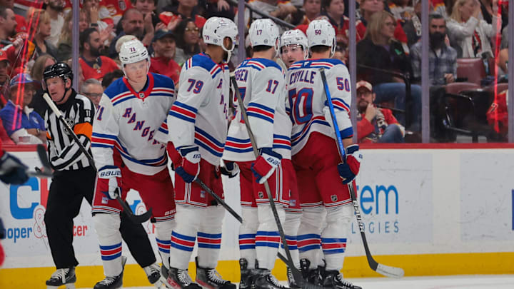 Apr 14, 2025; Sunrise, Florida, USA; New York Rangers center Juuso Parssinen (71) celebrates with teammates after scoring against the Florida Panthers during the second period at Amerant Bank Arena. Mandatory Credit: Sam Navarro-Imagn Images