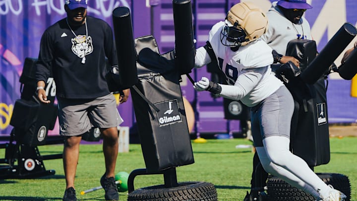 Caleb Smith works through a blocking-dummy drill in UW spring ball.