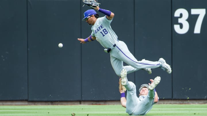 May 13, 2023; Stillwater, OK, USA; Kansas State Wildcats right fielder Cash Rugely (18) flips in the air after colliding with center fielder Brendan Jones (5) during the game against the Oklahoma State Cowboys at O'Brate Stadium (Brett Rojo-Imagn Images) May 13, 2023; Stillwater, OK, USA; Kansas State Wildcats right fielder Cash Rugely (18) flips in the air after colliding with center fielder Brendan Jones (5) during the game against the Oklahoma State Cowboys at O'Brate Stadium (Brett Rojo-Imagn Images)