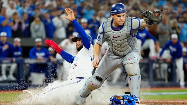 Toronto Blue Jays' Isiah Kiner-Falefa, left, is forced out at home plate by Los Angeles Dodgers catcher Will Smith during the ninth inning in Game 7 of baseball's World Series in Toronto on Saturday, Nov. 1, 2025.