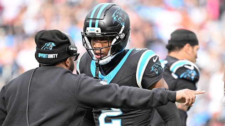 Dec 21, 2025; Charlotte, North Carolina, USA; Carolina Panthers cornerback Mike Jackson (2) talks to an assistant coach in the second quarter at Bank of America Stadium. 