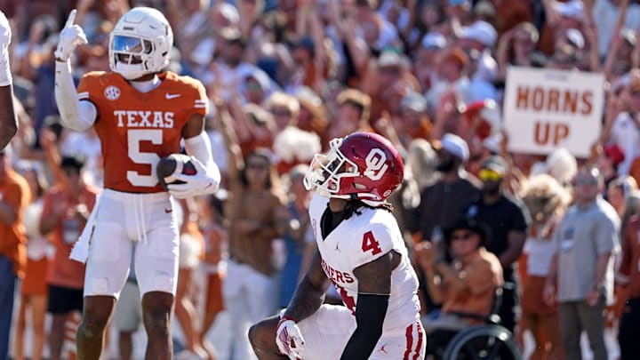 Oklahoma Sooners wide receiver Deion Burks (4) reacts after Texas Longhorns defensive back Malik Muhammad (5) intercepts a pass in the end zone in the first half of the Red River Rivalry college football game between the University of Oklahoma Sooners and the Texas Longhorn at the Cotton Bowl Stadium in Dallas, Texas, Saturday, Oct. 11, 2025. Oklahoma Sooners wide receiver Deion Burks (4) reacts after Texas Longhorns defensive back Malik Muhammad (5) intercepts a pass in the end zone in the first half of the Red River Rivalry college football game between the University of Oklahoma Sooners and the Texas Longhorn at the Cotton Bowl Stadium in Dallas, Texas, Saturday, Oct. 11, 2025.