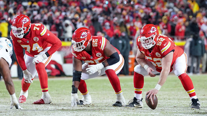 Jan 13, 2024; Kansas City, Missouri, USA; Kansas City Chiefs offensive tackle Jawaan Taylor (74) and guard Trey Smith (65) and center Creed Humphrey (52) at the line of scrimmage against the Miami Dolphins in a 2024 AFC wild card game at GEHA Field at Arrowhead Stadium. Mandatory Credit: Denny Medley-Imagn Images