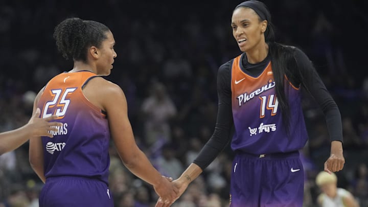 Phoenix Mercury forward Alyssa Thomas (25) slaps hands with Phoenix Mercury forward DeWanna Bonner (14) during the first quarter against the Minnesota Lynx at PHX Arena on July 9, 2025.