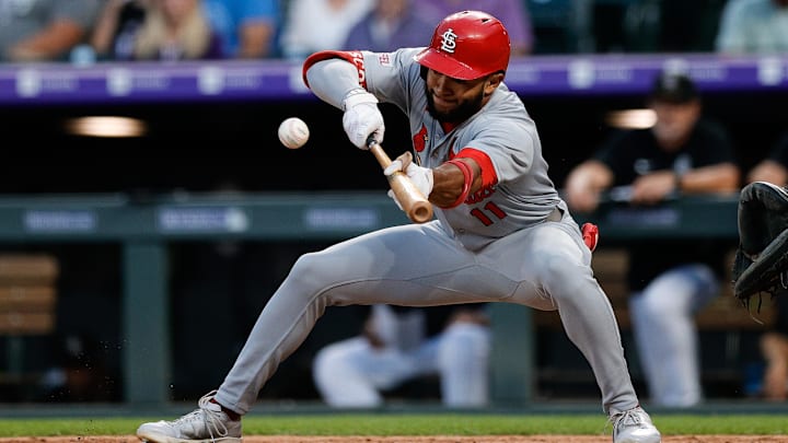 Jul 21, 2025; Denver, Colorado, USA; St. Louis Cardinals center fielder Victor Scott II (11) bunts in the sixth inning against the Colorado Rockies at Coors Field. Mandatory Credit: Isaiah J. Downing-Imagn Images