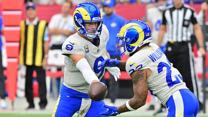 Sep 15, 2024; Glendale, Arizona, USA;  Los Angeles Rams quarterback Matthew Stafford (9) hands off to running back Kyren Williams (23) in the first half against the Arizona Cardinals at State Farm Stadium. Mandatory Credit: Matt Kartozian-Imagn Images