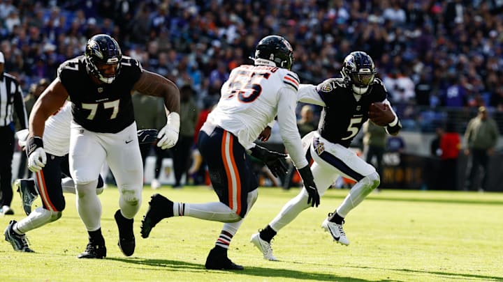 Oct 26, 2025; Baltimore, Maryland, USA; Baltimore Ravens quarterback Tyler Huntley (5) runs with the ball as Chicago Bears defensive end Dayo Odeyingbo (55) chases in the third quarter at M&T Bank Stadium. Mandatory Credit: Geoff Burke-Imagn Images