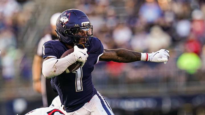 Connecticut Huskies wide receiver Skyler Bell runs the ball against the Ball State Cardinals. Connecticut Huskies wide receiver Skyler Bell runs the ball against the Ball State Cardinals.