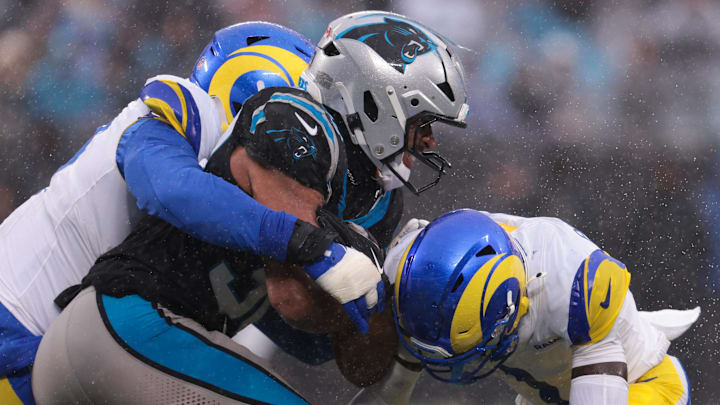 Nov 30, 2025; Charlotte, North Carolina, USA; Carolina Panthers running back Chuba Hubbard (30) rushes as Los Angeles Rams cornerback Emmanuel Forbes Jr. (1) defends during the third quarter at Bank of America Stadium. Mandatory Credit: Scott Kinser-Imagn Images