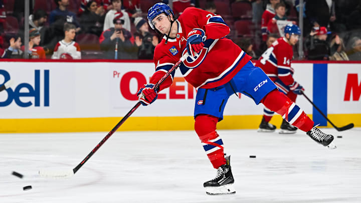 Feb 8, 2025; Montreal, Quebec, CAN; Montreal Canadiens defenseman Logan Mailloux (24) shoots a puck during warm-up before the game against the New Jersey Devils at Bell Centre. Mandatory Credit: David Kirouac-Imagn Images