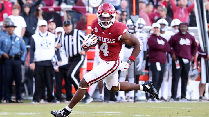 Nov 1, 2025; Fayetteville, Arkansas, USA; Arkansas Razorbacks running back Mike Washington Jr (4) rushes for a touchdown during the third quarter against the Mississippi State Bulldogs at Donald W. Reynolds Razorback Stadium. Bulldogs won 38-35. Mandatory Credit: Nelson Chenault-Imagn Images