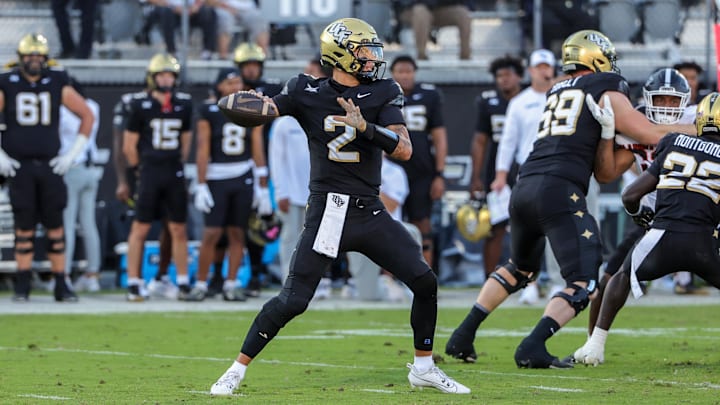 Nov 22, 2025; Orlando, Florida, USA; UCF Knights quarterback Tayven Jackson (2) drops back to pass during the first quarter against the Oklahoma State Cowboys at Acrisure Bounce House. Mandatory Credit: Mike Watters-Imagn Images