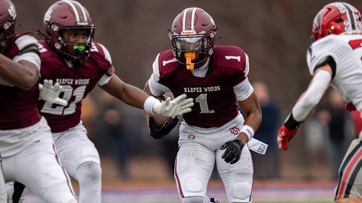 Harper Woods wide receiver Dakota Guerrant (1) runs the ball against the Divine Child High School defense during a Division 4 regional final at John Glenn High School in Westland on Saturday, Nov. 15, 2025.