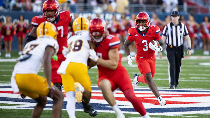 Nov 30, 2024; Tucson, Arizona, USA; Arizona Wildcats running back Kedrick Reescano (3) against the Arizona State Sun Devils during the Territorial Cup at Arizona Stadium. Mandatory Credit: Mark J. Rebilas-Imagn Images Nov 30, 2024; Tucson, Arizona, USA; Arizona Wildcats running back Kedrick Reescano (3) against the Arizona State Sun Devils during the Territorial Cup at Arizona Stadium. Mandatory Credit: Mark J. Rebilas-Imagn Images