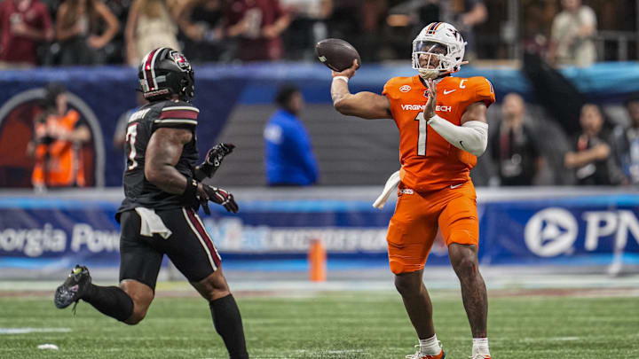 Aug 31, 2025; Atlanta, Georgia, USA; Virginia Tech Hokies quarterback Kyron Drones (1) passes over South Carolina Gamecocks linebacker Shawn Murphy (7) during the second half at Mercedes-Benz Stadium. Mandatory Credit: Dale Zanine-Imagn Images Aug 31, 2025; Atlanta, Georgia, USA; Virginia Tech Hokies quarterback Kyron Drones (1) passes over South Carolina Gamecocks linebacker Shawn Murphy (7) during the second half at Mercedes-Benz Stadium. Mandatory Credit: Dale Zanine-Imagn Images