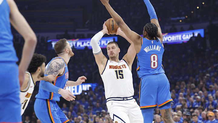 May 18, 2025; Oklahoma City, Oklahoma, USA; Denver Nuggets center Nikola Jokic (15) is defended by Oklahoma City Thunder center Isaiah Hartenstein (55) and guard Shai Gilgeous-Alexander (2) as he passes the ball in the first quarter during game seven of the second round for the 2025 NBA Playoffs at Paycom Center. Mandatory Credit: Alonzo Adams-Imagn Images