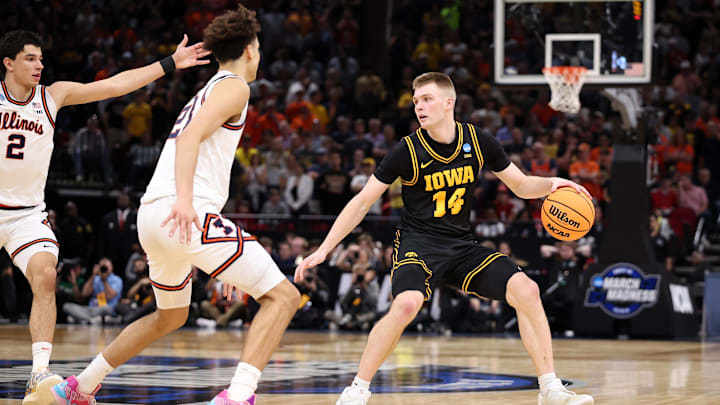 Mar 28, 2026; Houston, TX, USA; Iowa Hawkeyes guard Bennett Stirtz (14) controls the ball against Illinois Fighting Illini guard Keaton Wagler (23) in the second half during an Elite Eight game of the South Regional of the men's 2026 NCAA Tournament at Toyota Center. Mandatory Credit: Troy Taormina-Imagn Images