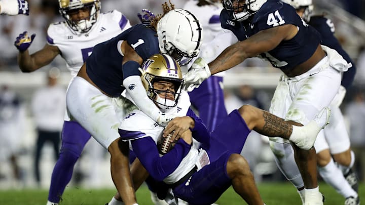 Nov 9, 2024; University Park, Pennsylvania, USA; Washington Huskies quarterback Demond Williams Jr (2) is tackled by Penn State Nittany Lions safety Jaylen Reed (1) during the third quarter at Beaver Stadium. Penn State won 35-6. Mandatory Credit: Matthew O'Haren-Imagn Images