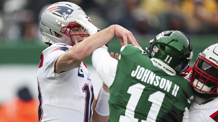 Dec 28, 2025; East Rutherford, New Jersey, USA; New York Jets linebacker Jermaine Johnson (11) is called for roughing the passer, New England Patriots quarterback Drake Maye (10) during the second quarter of the game at MetLife Stadium. Mandatory Credit: Vincent Carchietta-Imagn Images