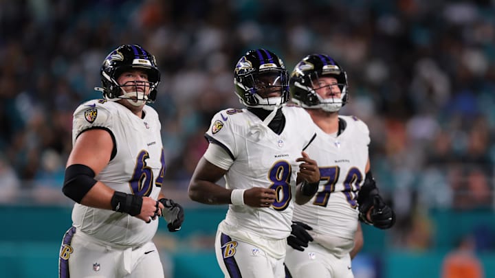 Oct 30, 2025; Miami Gardens, Florida, USA; Baltimore Ravens quarterback Lamar Jackson (8) runs up to the line with center Tyler Linderbaum (64) and offensive tackle Roger Rosengarten (70) during the third quarter against the Miami Dolphins at Hard Rock Stadium. Mandatory Credit: Sam Navarro-Imagn Images