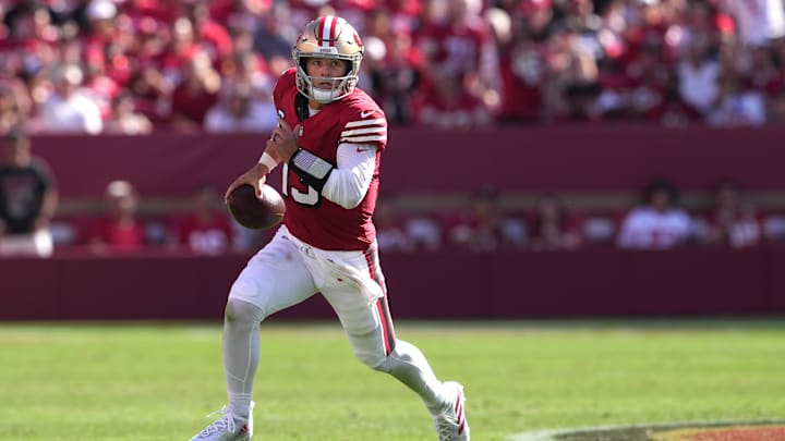 Oct 6, 2024; Santa Clara, California, USA; San Francisco 49ers quarterback Brock Purdy (13) carries the ball against the Arizona Cardinals during the third quarter at Levi's Stadium. Mandatory Credit: Darren Yamashita-Imagn Images