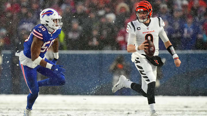 Cincinnati Bengals quarterback Joe Burrow (9) carries the ball as Buffalo Bills defensive end Greg Rousseau (50) defends in the second quarter during an NFL divisional playoff football game between the Cincinnati Bengals and the Buffalo Bills, Sunday, Jan. 22, 2023 Cincinnati Bengals quarterback Joe Burrow (9) carries the ball as Buffalo Bills defensive end Greg Rousseau (50) defends in the second quarter during an NFL divisional playoff football game between the Cincinnati Bengals and the Buffalo Bills, Sunday, Jan. 22, 2023