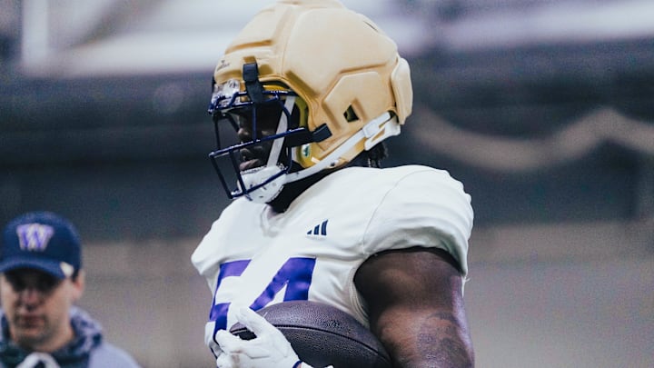 Anterio Thompson grips a football during spring ball. 