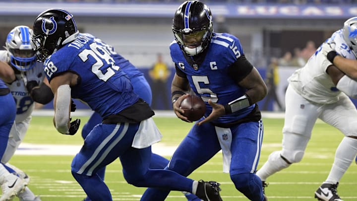 Nov 24, 2024; Indianapolis, Indiana, USA; Indianapolis Colts quarterback Anthony Richardson (5) fakes a hand off to Indianapolis Colts running back Jonathan Taylor (28) during the second quarter against the Detroit Lions at Lucas Oil Stadium. Mandatory Credit: Marc Lebryk-Imagn Images