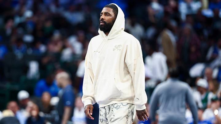 Oct 22, 2025; Dallas, Texas, USA; Dallas Mavericks injured guard Kyrie Irving walks across the court during the game against the San Antonio Spurs at American Airlines Center. Oct 22, 2025; Dallas, Texas, USA; Dallas Mavericks injured guard Kyrie Irving walks across the court during the game against the San Antonio Spurs at American Airlines Center.