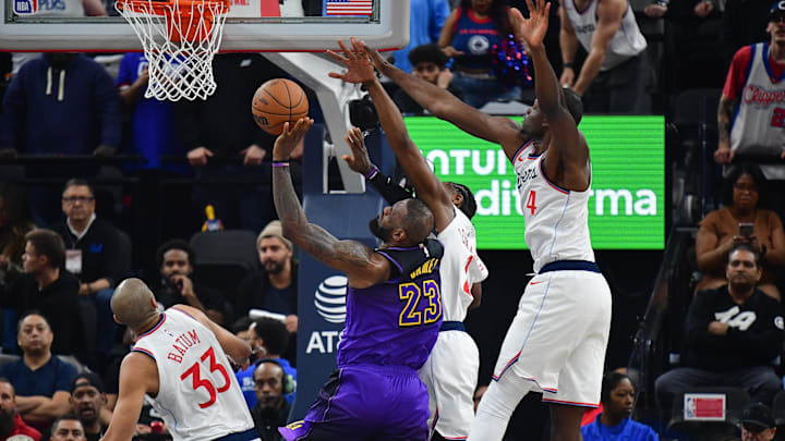 Jan 19, 2025; Inglewood, California, USA; Los Angeles Clippers forward Kawhi Leonard (2) and center Mo Bamba (4) defend against Los Angeles Lakers forward LeBron James (23) during the first half at Intuit Dome. Mandatory Credit: Gary A. Vasquez-Imagn Images