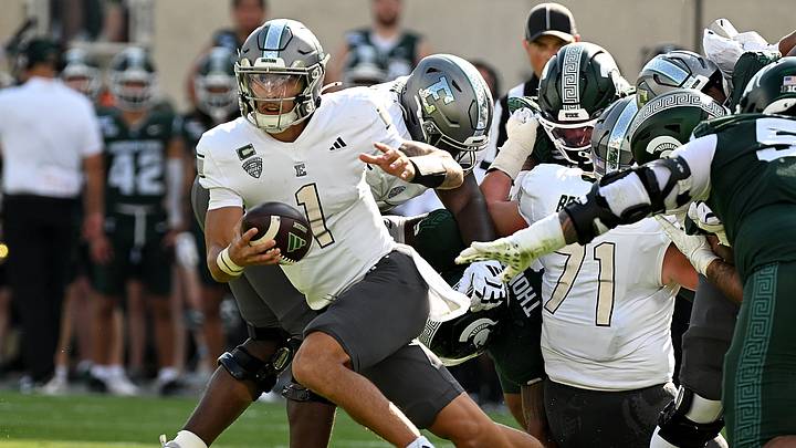 Sep 12, 2026; East Lansing, Michigan, USA; Eastern Michigan Eagles quarterback Noah Kim (1) sprints out of the pocket during the second quarter against the Michigan State Spartans at Spartan Stadium. Mandatory Credit: Dale Young-Imagn Images Sep 12, 2026; East Lansing, Michigan, USA; Eastern Michigan Eagles quarterback Noah Kim (1) sprints out of the pocket during the second quarter against the Michigan State Spartans at Spartan Stadium. Mandatory Credit: Dale Young-Imagn Images