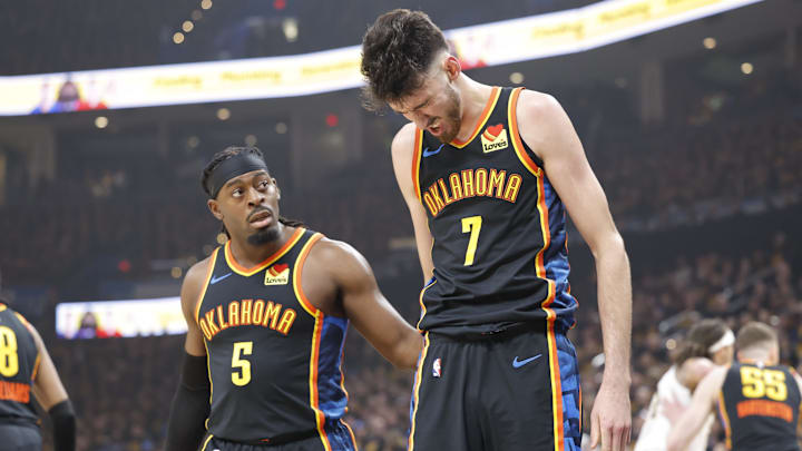 May 5, 2025; Oklahoma City, Oklahoma, USA; Oklahoma City Thunder guard Luguentz Dort (5) checks on forward Chet Holmgren (7) after he was hit during a play against the Denver Nuggets during the first quarter during game one of the second round for the 2025 NBA Playoffs at Paycom Center. Mandatory Credit: Alonzo Adams-Imagn Images