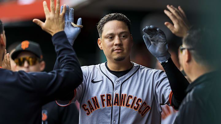 Mar 29, 2025; Cincinnati, Ohio, USA; San Francisco Giants first baseman Wilmer Flores (41) high fives teammates after hitting a solo home run in the second inning against the Cincinnati Reds at Great American Ball Park.