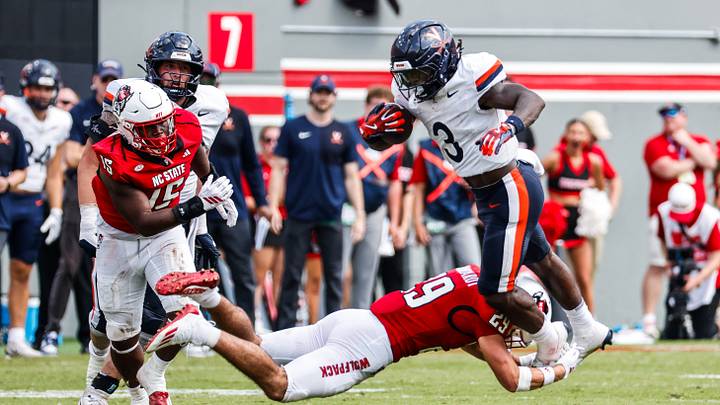 Sep 6, 2025; Raleigh, North Carolina, USA; North Carolina State Wolfpack safety Brody Barnhardt (29) tackles Virginia Cavaliers running back J'Mari Taylor (3) during the second half of the game at Carter-Finley Stadium. Mandatory Credit: Jaylynn Nash-Imagn Images Sep 6, 2025; Raleigh, North Carolina, USA; North Carolina State Wolfpack safety Brody Barnhardt (29) tackles Virginia Cavaliers running back J'Mari Taylor (3) during the second half of the game at Carter-Finley Stadium. Mandatory Credit: Jaylynn Nash-Imagn Images
